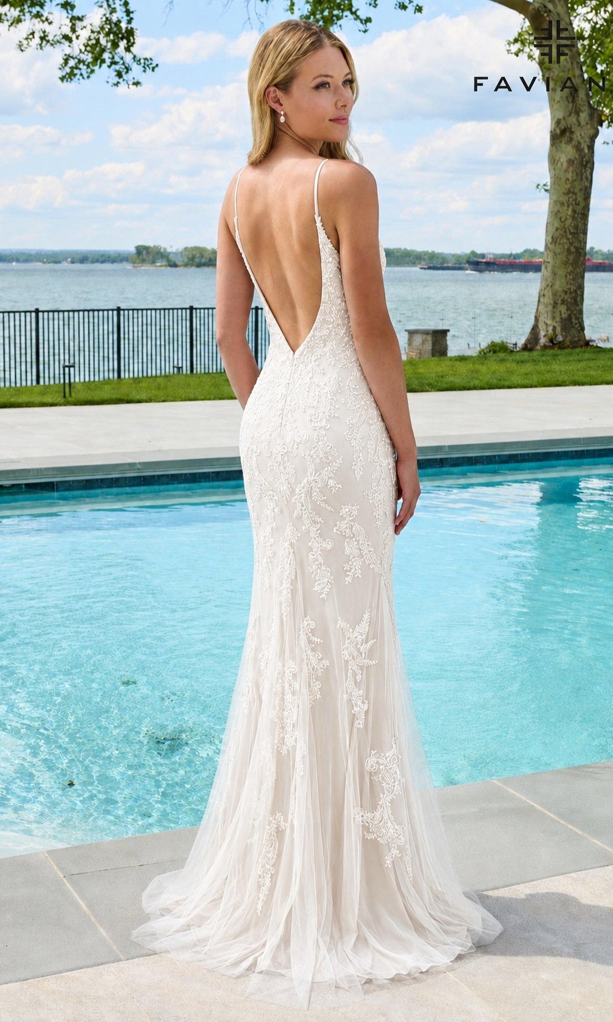 A woman wearing the Long Prom Dress: Faviana 11678, a floor-length, backless white gown with intricate beaded lace appliques, standing by a swimming pool.